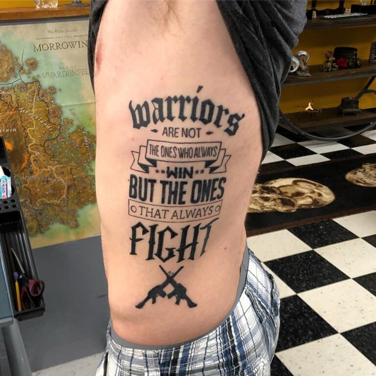 Tattoo on a person's side featuring the quote about warriors emphasizing resilience and the spirit of fighting.