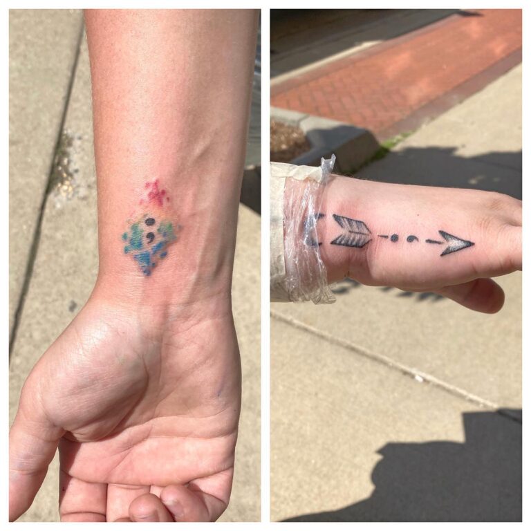 A colorful, faded tattoo of an ice cream cone on one wrist and a bold black arrow tattoo on the other.